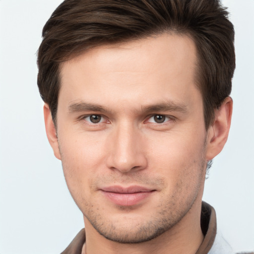 Joyful white young-adult male with short  brown hair and brown eyes