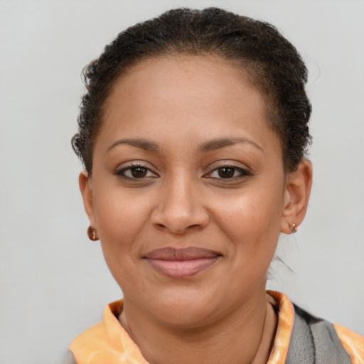 Joyful latino young-adult female with short  brown hair and brown eyes