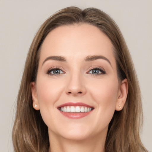 Joyful white young-adult female with long  brown hair and grey eyes