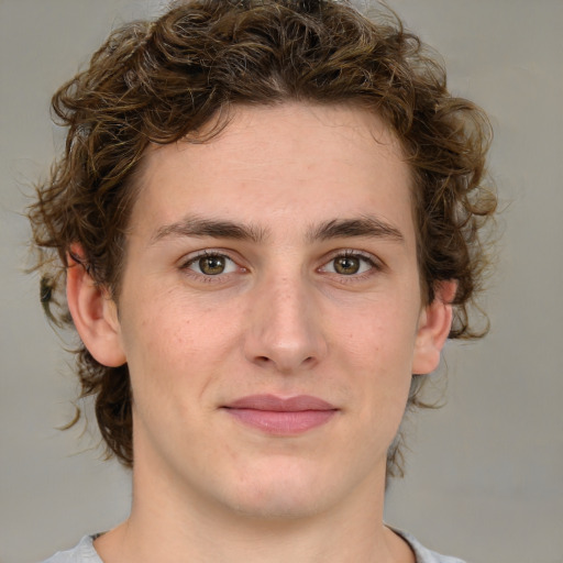 Joyful white young-adult male with medium  brown hair and green eyes