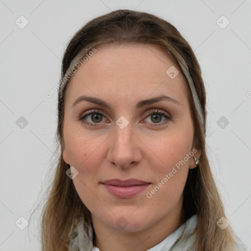 Joyful white young-adult female with long  brown hair and green eyes