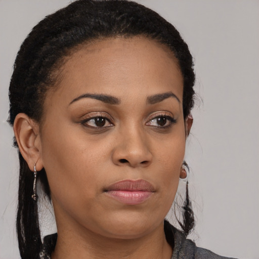 Joyful black young-adult female with medium  black hair and brown eyes