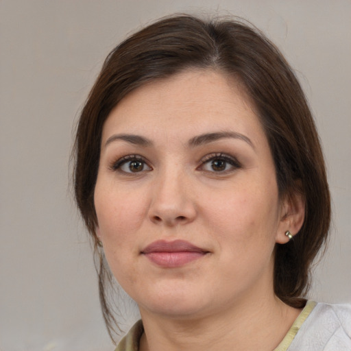 Joyful white young-adult female with medium  brown hair and brown eyes