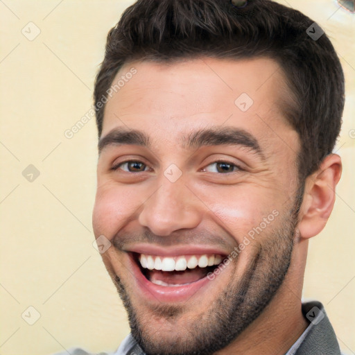 Joyful white young-adult male with short  black hair and brown eyes