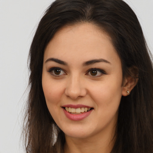 Joyful white young-adult female with long  brown hair and brown eyes