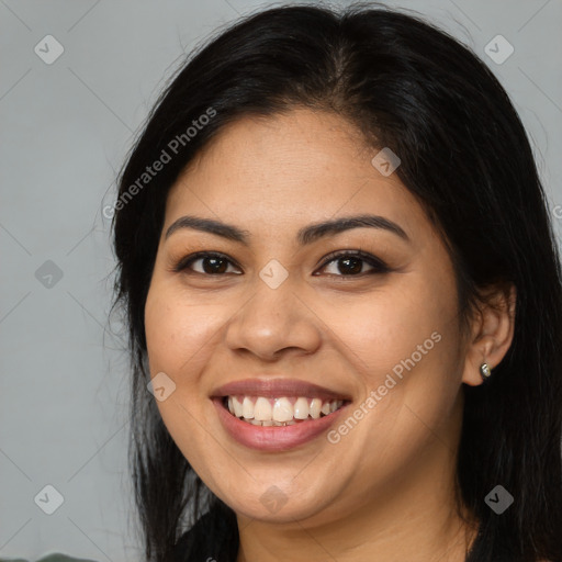 Joyful latino young-adult female with long  brown hair and brown eyes