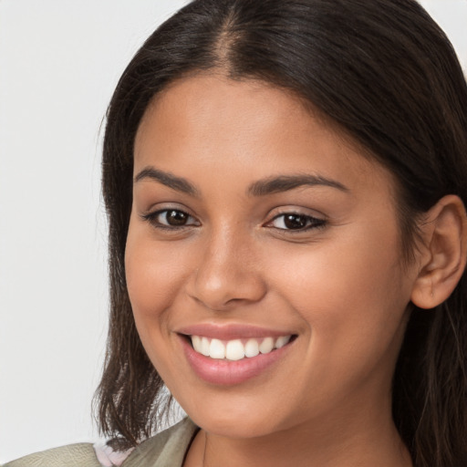 Joyful white young-adult female with long  brown hair and brown eyes