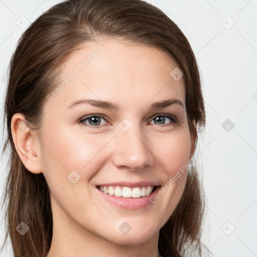 Joyful white young-adult female with long  brown hair and grey eyes