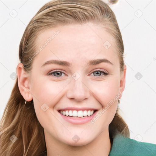 Joyful white young-adult female with long  brown hair and blue eyes