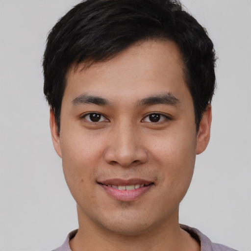 Joyful asian young-adult male with short  black hair and brown eyes