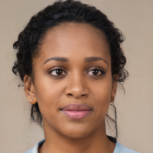 Joyful black young-adult female with medium  brown hair and brown eyes