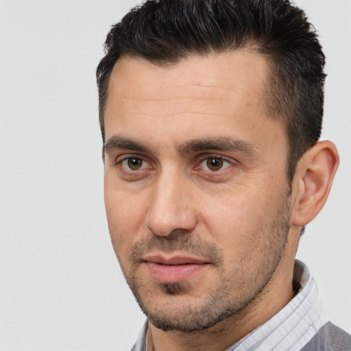 Joyful white adult male with short  brown hair and brown eyes