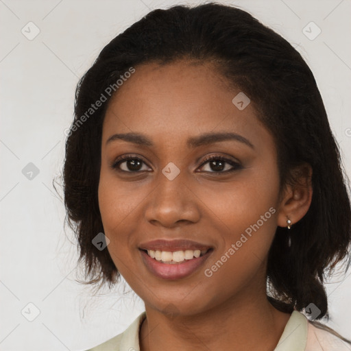 Joyful black young-adult female with medium  brown hair and brown eyes