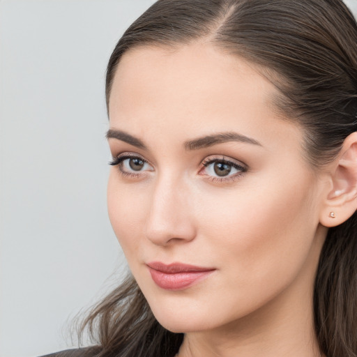 Neutral white young-adult female with long  brown hair and brown eyes