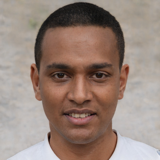 Joyful black young-adult male with short  black hair and brown eyes