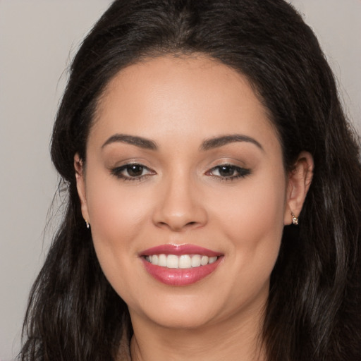 Joyful white young-adult female with long  black hair and brown eyes