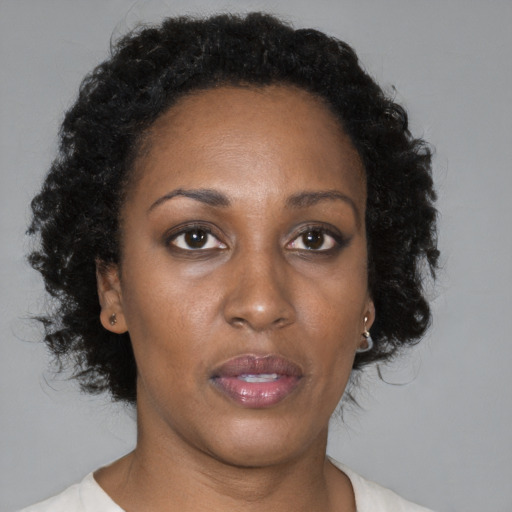 Neutral black adult female with medium  brown hair and brown eyes