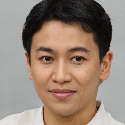 Joyful asian young-adult male with short  brown hair and brown eyes