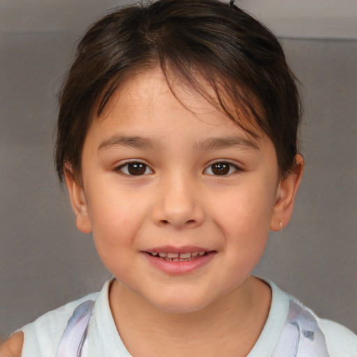 Joyful white child female with short  brown hair and brown eyes