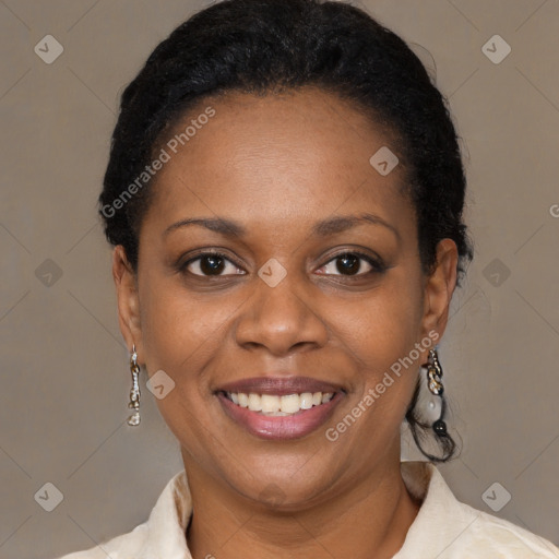 Joyful black adult female with short  brown hair and brown eyes