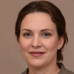 Joyful white adult female with medium  brown hair and brown eyes