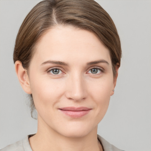 Joyful white young-adult female with short  brown hair and grey eyes