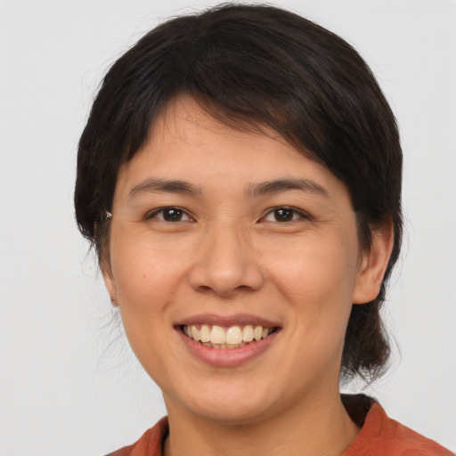 Joyful asian young-adult female with medium  brown hair and brown eyes