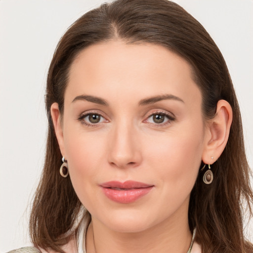 Joyful white young-adult female with long  brown hair and grey eyes