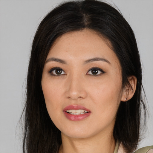 Joyful asian young-adult female with long  brown hair and brown eyes
