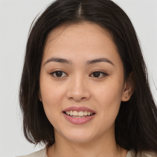 Joyful white young-adult female with long  brown hair and brown eyes