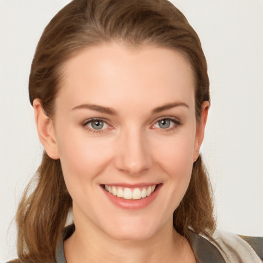 Joyful white young-adult female with medium  brown hair and grey eyes