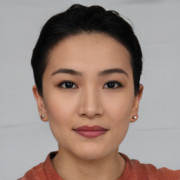 Joyful asian young-adult female with short  black hair and brown eyes