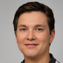 Joyful white adult male with short  brown hair and grey eyes