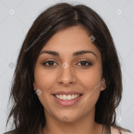 Joyful latino young-adult female with long  brown hair and brown eyes