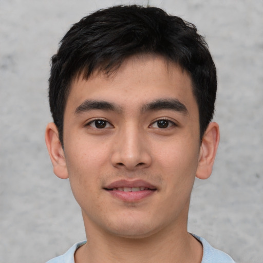 Joyful asian young-adult male with short  brown hair and brown eyes