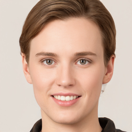 Joyful white young-adult female with short  brown hair and grey eyes