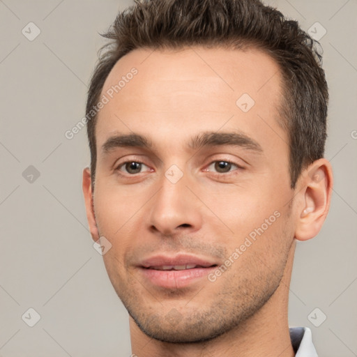 Joyful white young-adult male with short  brown hair and brown eyes