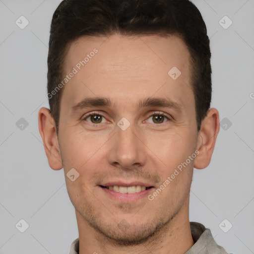 Joyful white young-adult male with short  brown hair and grey eyes