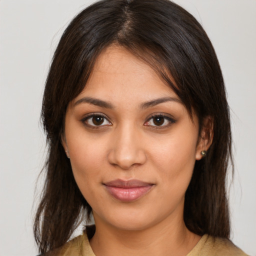 Joyful latino young-adult female with medium  brown hair and brown eyes