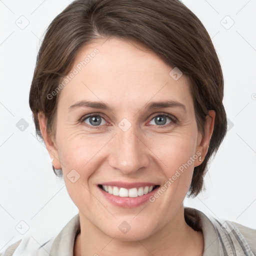 Joyful white young-adult female with medium  brown hair and grey eyes