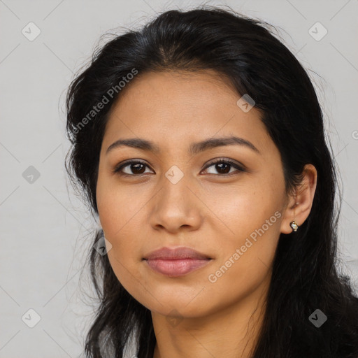 Joyful latino young-adult female with long  brown hair and brown eyes