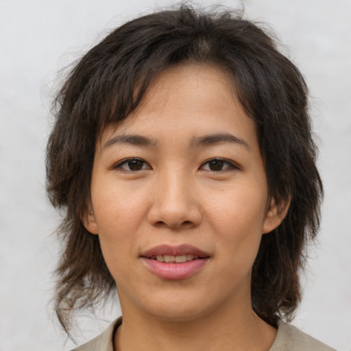 Joyful asian young-adult female with medium  brown hair and brown eyes