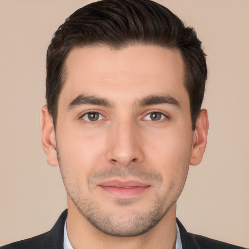 Joyful white young-adult male with short  brown hair and brown eyes