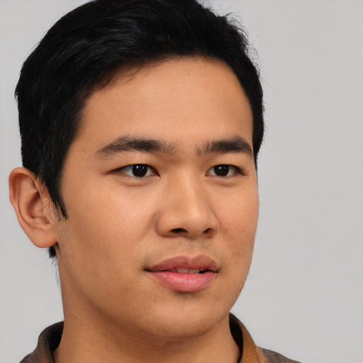 Joyful asian young-adult male with short  brown hair and brown eyes