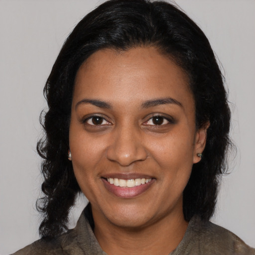 Joyful black young-adult female with medium  black hair and brown eyes