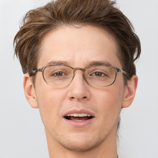 Joyful white adult male with short  brown hair and grey eyes