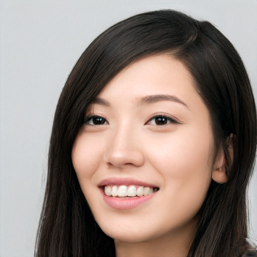 Joyful white young-adult female with long  black hair and brown eyes