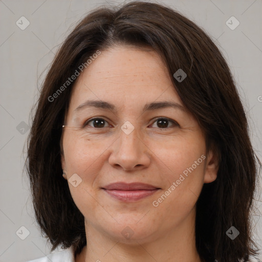 Joyful white adult female with medium  brown hair and brown eyes