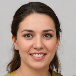 Joyful white young-adult female with medium  brown hair and brown eyes