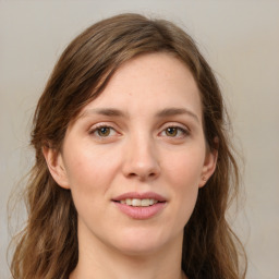 Joyful white young-adult female with long  brown hair and green eyes